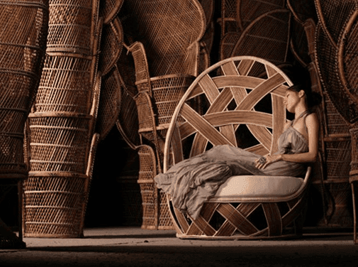 Woman seated in a woven rattan chair
